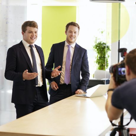 Cameraman and two businessmen making a corporate video